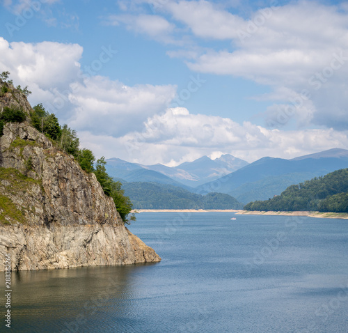 mountain view from vidraru lake on transfagarasan road romania, with negoiu peak in the distance photo