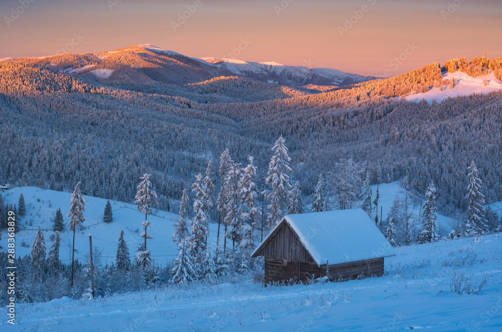 Wooden house on a hill covered with fresh snow