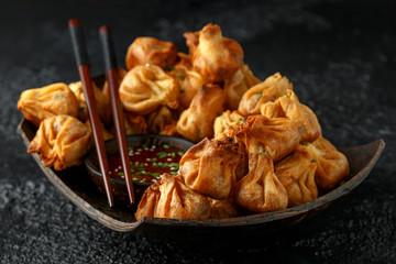 Chinese takeaway finger food Vegetable wontons with sweet chilli dip sauce and chop sticks