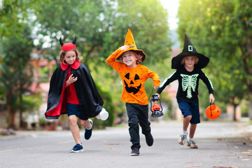 Kids trick or treat. Halloween fun for children.