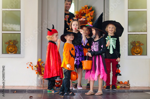 Kids trick or treat. Halloween. Child at door.