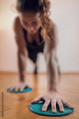 Female Athlete Exercising with Sliding Discs.