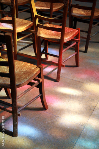 stained glass illumination on church chairs 