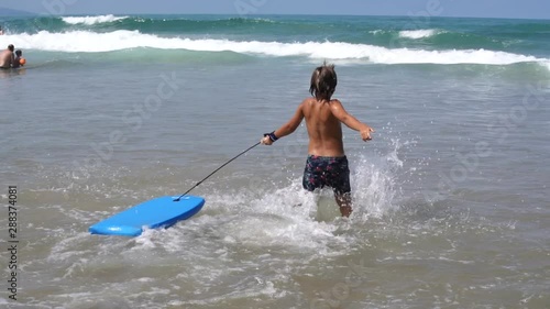 Young children bodyboarding in the Atlantic ocean