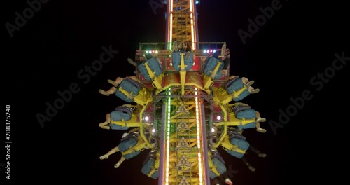 People plunging from the sky in a tower drop carnival ride