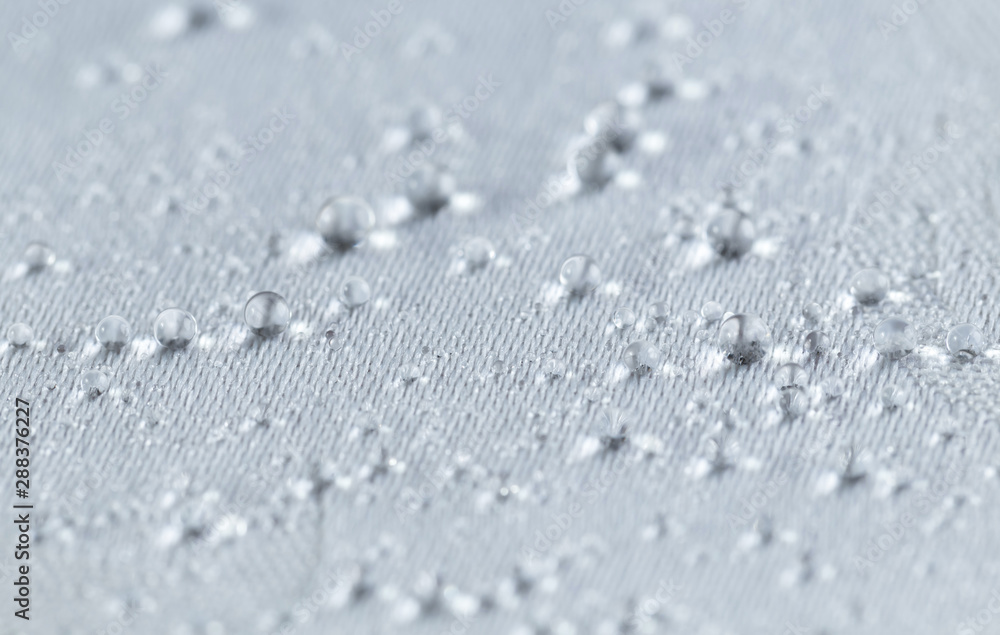 Obraz premium Water drops on white waterproof fabric. Horizontal image.