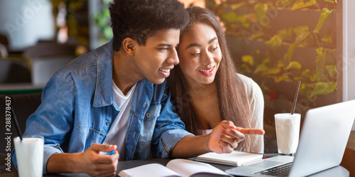 Wallpaper Mural Black teenager showing his girlfriend new educational website Torontodigital.ca
