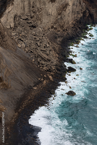 aerial image of water hitting the black lavacoast of the new land of Capelinos volano after the 1957 volcanic eruptions