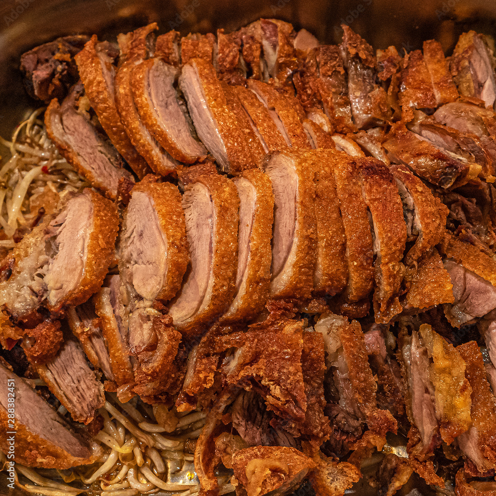 Asian fast food style, fried duck with Chinese noodles at big metal tray