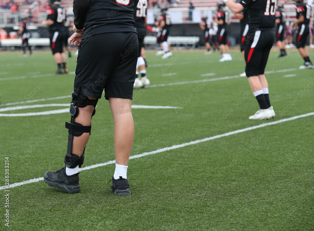 An injured player walks around as his teammates warm up An injured player walks around as his teammates warm up