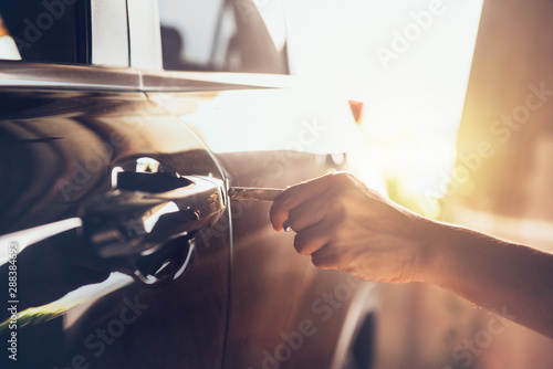 Woman hand holding the key remote control to unlock the car door