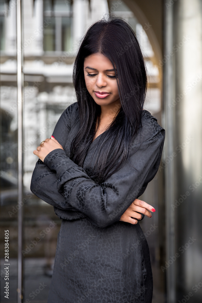 Fashion portrait of an indian stylish woman long hair and black business dress