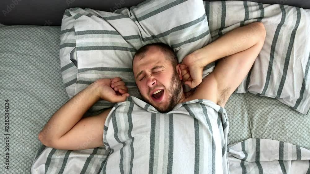 Top view of young man is sleeping in the bed. Top view of young man is sleeping in the bed.