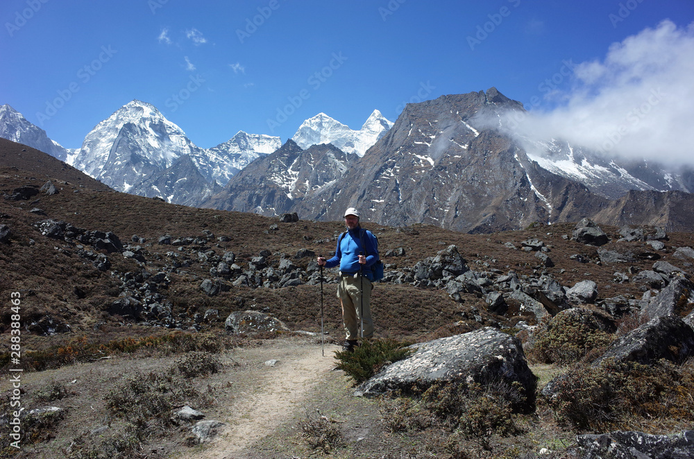 Trekker is standing on the trail to Ama Dablam base camp - acclimatization day trip from Pangboche village, Everest trek, Sagarmatha national park, Solukhumbu, Nepal
