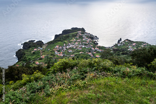 View on the village of Fajã do Ouvidor, a permanent debris field, built from the collapsing cliffs on the northern coast of the civil parish of Norte Grande photo