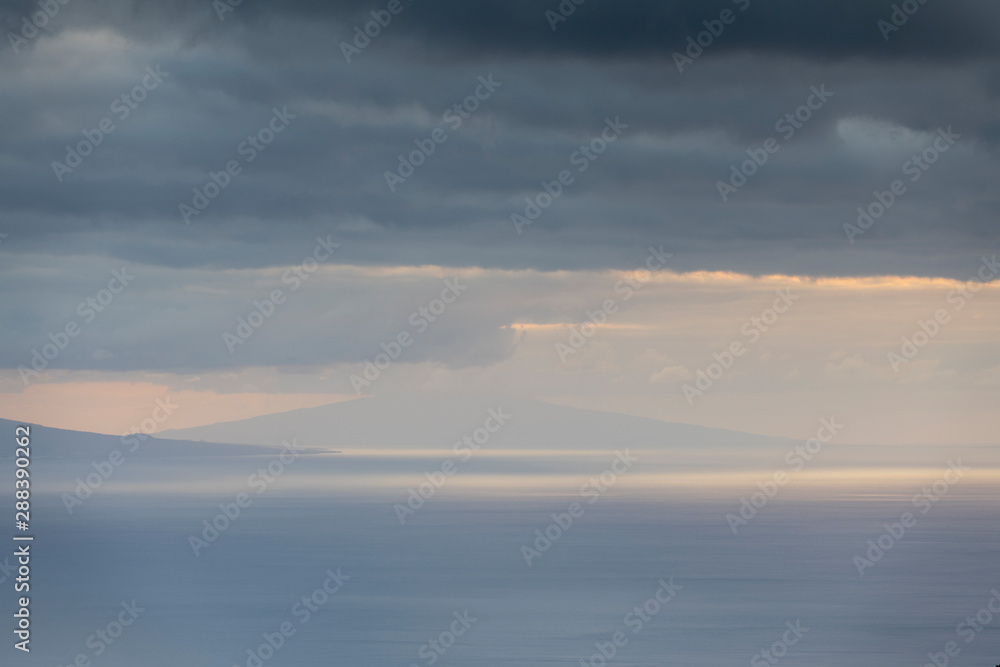 Landscape image showing cloud layers over Faial island as seen from Sao Jorge Island, Azores