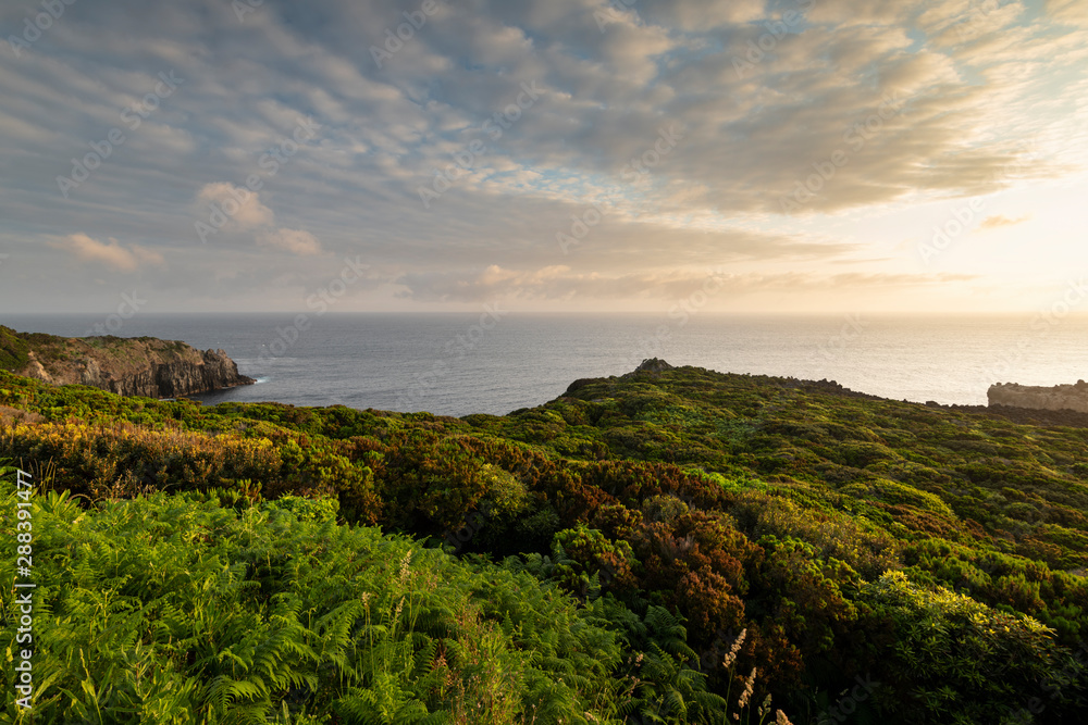 Amazing green landscape at sunrise at the mirador de Alagoa of the Agualva coastline on Terceira, Azores