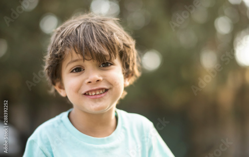little three years old boy portraits in summer afternoon photo