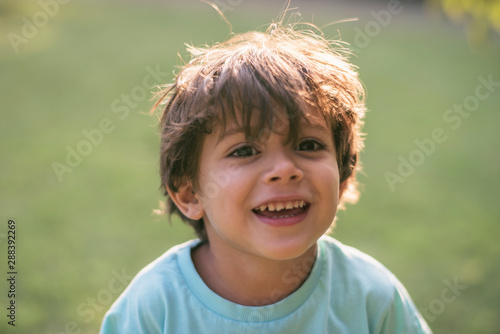 little three years old boy portrits in summer afternoon photo