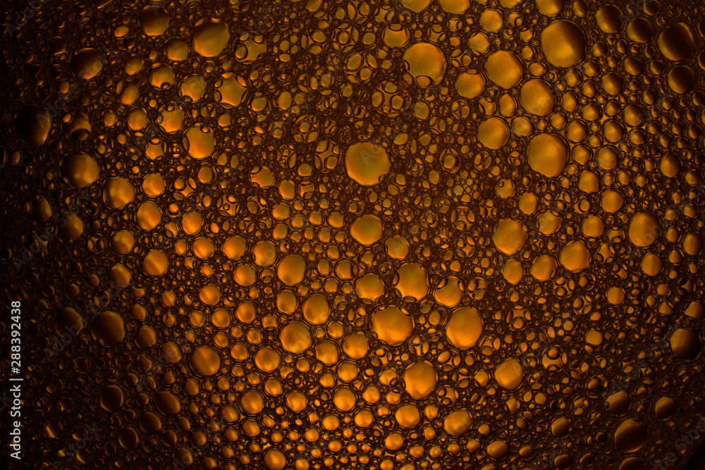 Naklejka premium oil bubbles macro on colourful background photography