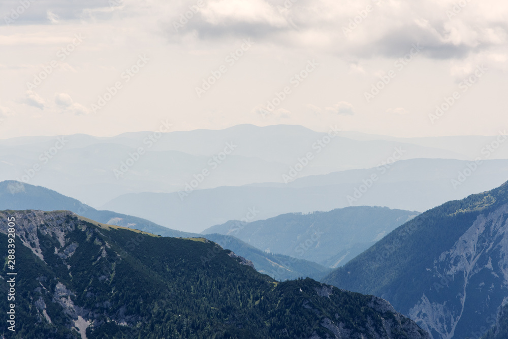 view of mountain peaks in haze, Alps