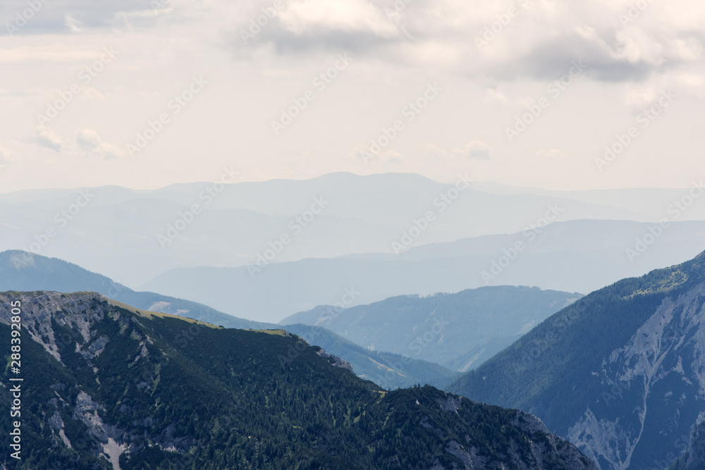 Obraz premium view of mountain peaks in haze, Alps
