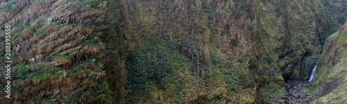 Panorama of a beautiful river valley with a rich vegetation and cascata da ribeira da tosquiada waterfall at the eastcoast (Nordeste) of Sao Miguel island