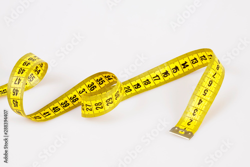 Slim concept with scale and measuring tape on white background top view