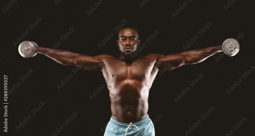African american bodybuilder lifting dumbbells up with straight arms