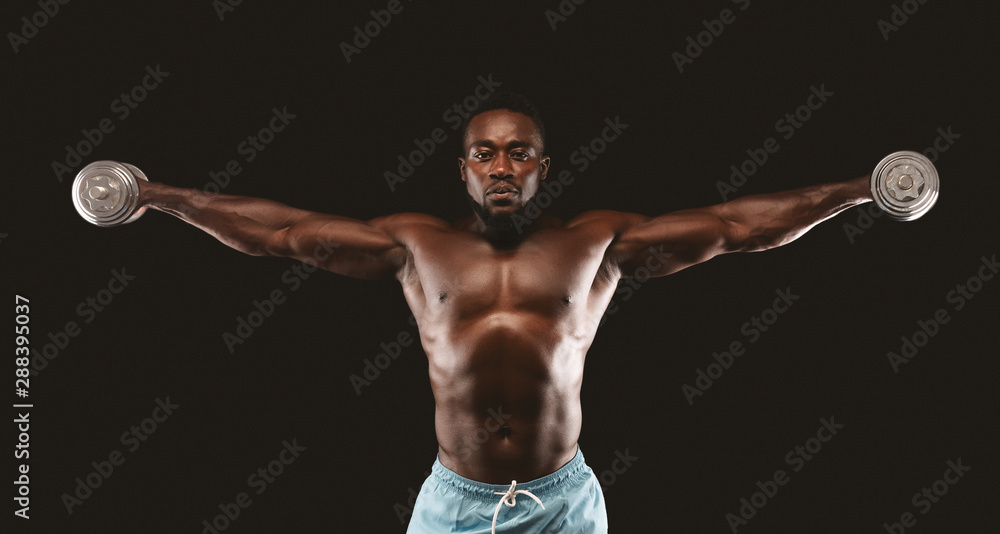 African american bodybuilder lifting dumbbells up with straight arms African american bodybuilder lifting dumbbells up with straight arms
