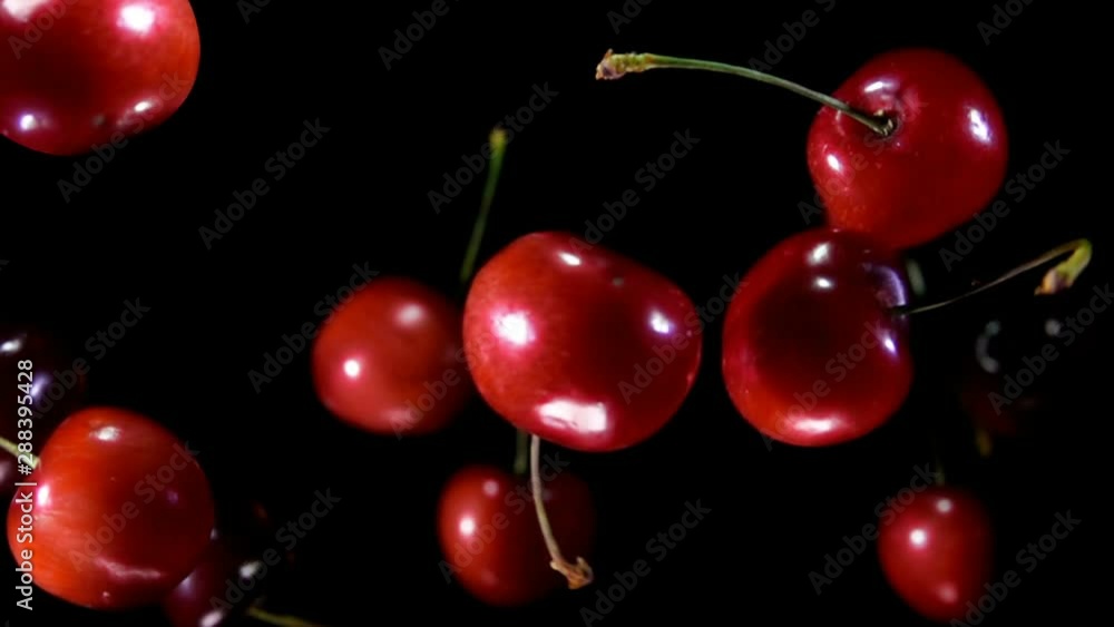 Cherry bouncing against to the camera on a black background in slow motion super close-up Cherry bouncing against to the camera on a black background in slow motion super close-up