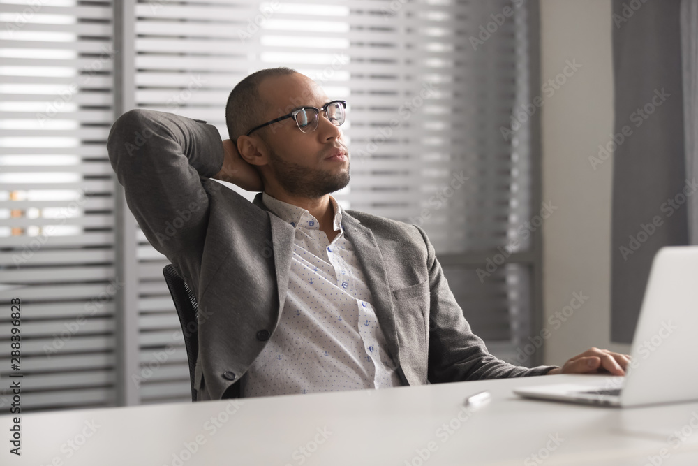 Naklejka premium Stressed african american businessman trying to relax at office.
