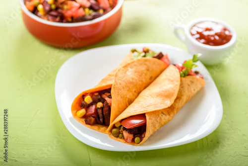Tacos - delicious tortillas with meat and vegetables © Robert Latawiec