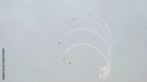 Several aircraft simultaneously perform loop-the-loops. Very spectacular. Airshow