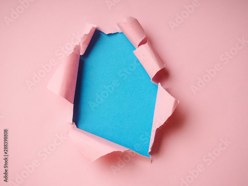Wrinkled ripped torn red paper with hole in center background texture poster backdrop empty space