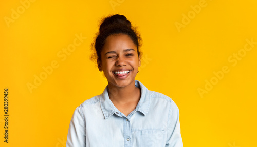 Photography Playful teen girl winking and sticking out tongue