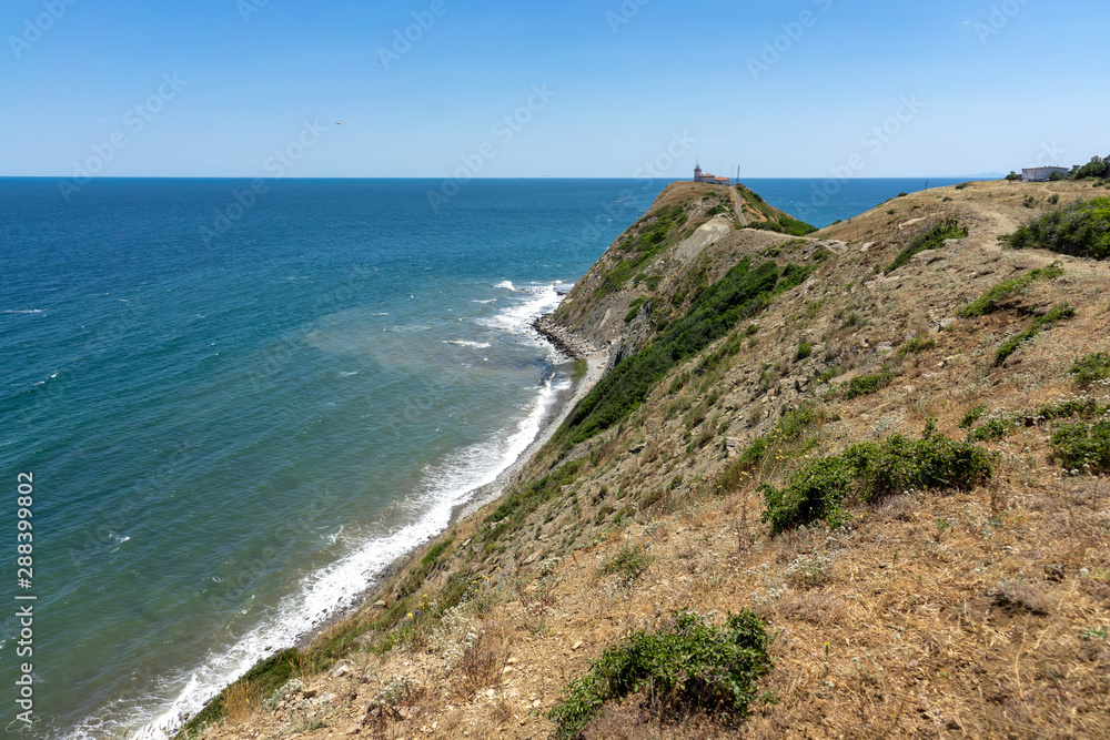 Natural landscape. The rocky coast of Cape Emine. The Bulgarian Black Sea Coast. In the background is the lighthouse building.