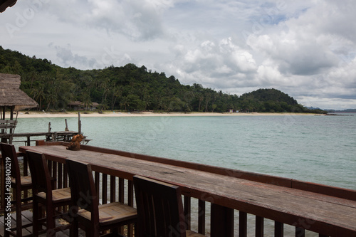 a Wooden bar table and chairs in front of the sea  Koh Talu Island  Thailand