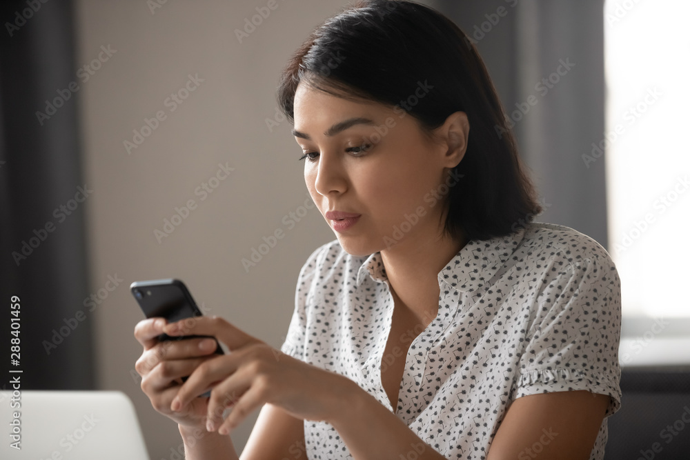 Concentrated asian japanese business woman texting message in cellphone. Concentrated asian japanese business woman texting message in cellphone.