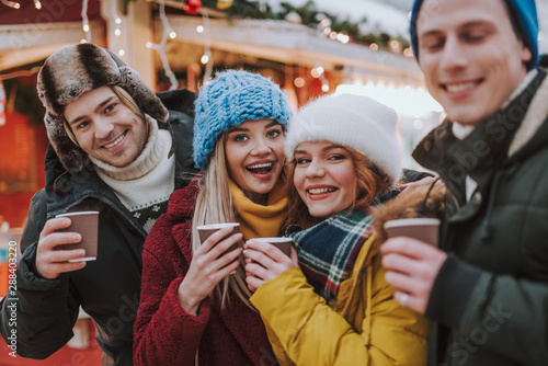 Delighted young people spending weekends together outdoors