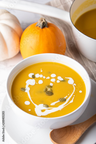 traditional squash soup with pumpkin on background