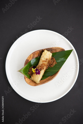 Filipino dessert wrapped in banana leaves photo