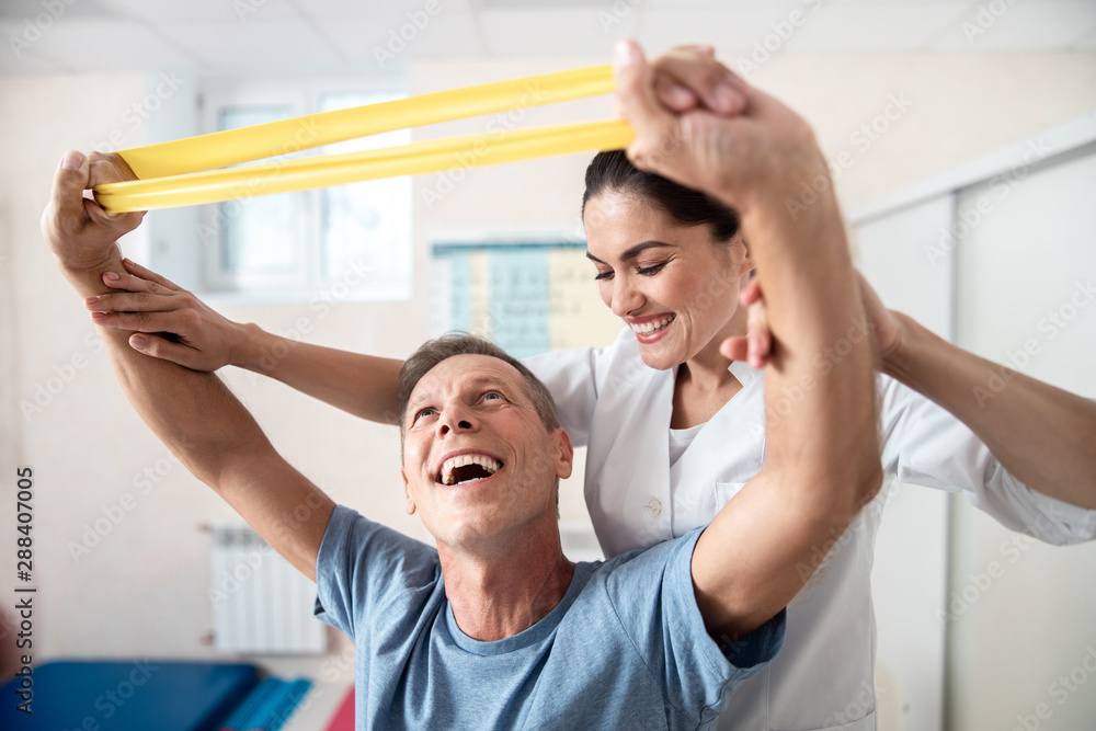 Happy man is doing stretching rehab exercises Happy man is doing stretching rehab exercises