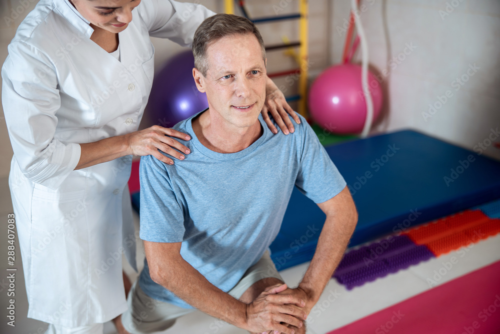 Smiling man man lunging with legs in room Smiling man man lunging with legs in room