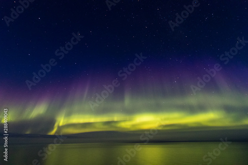 Northern Boreal Lights at sea in Lady Richardson Bay, Victoria Island, northwest passage in Canada.