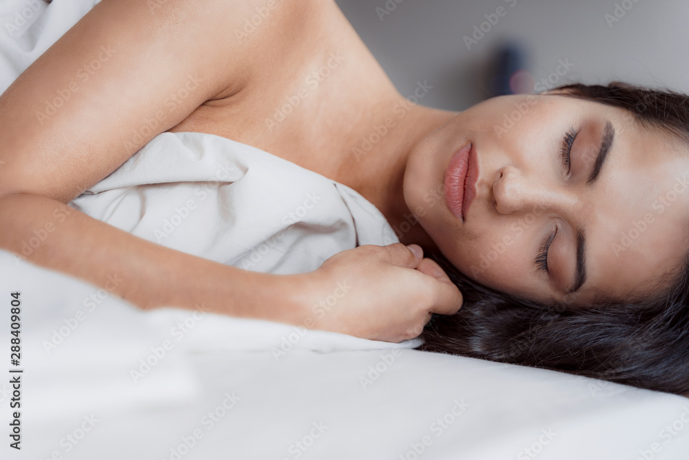 Good-looking woman smiling in her morning sleep