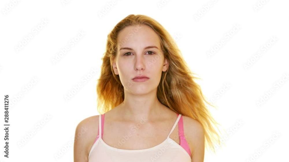 Seductive blonde girl with windblown hair looks intently at the camera Seductive blonde girl with windblown hair looks intently at the camera