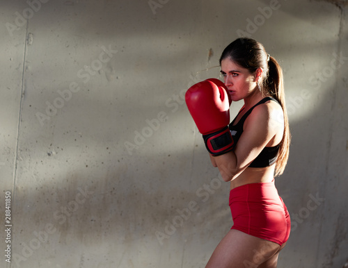 female boxer hitting outside photo