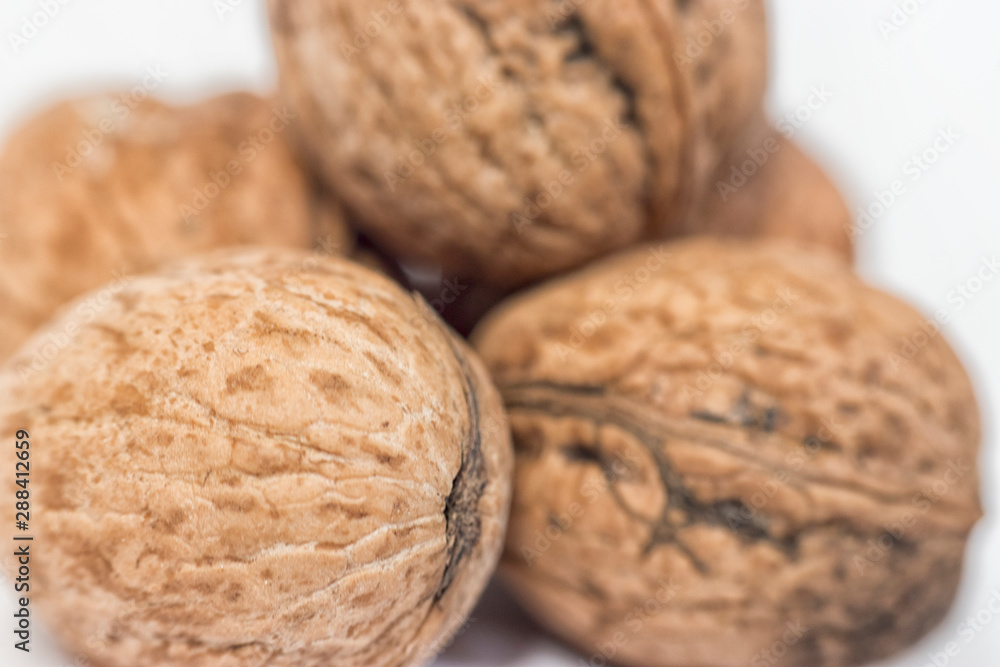 Close-up of five shelled walnuts over a white background stock macro photo Close-up of five shelled walnuts over a white background stock macro photo
