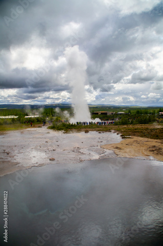 View of erupting Geysir, popular geothermal natural tourist travel attraction on Golden Circle, Iceland.
